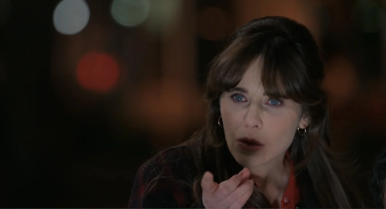 Harold and the Purple Crayon (2024) movie still: closeup — A dark outdoor space at night serves as the backdrop for a conversation. A woman with…