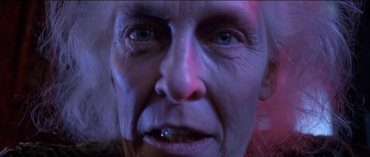 The Frighteners (1996) movie still: closeup — A close up view of an elderly individual face filling the frame. They are staring directly downward at…