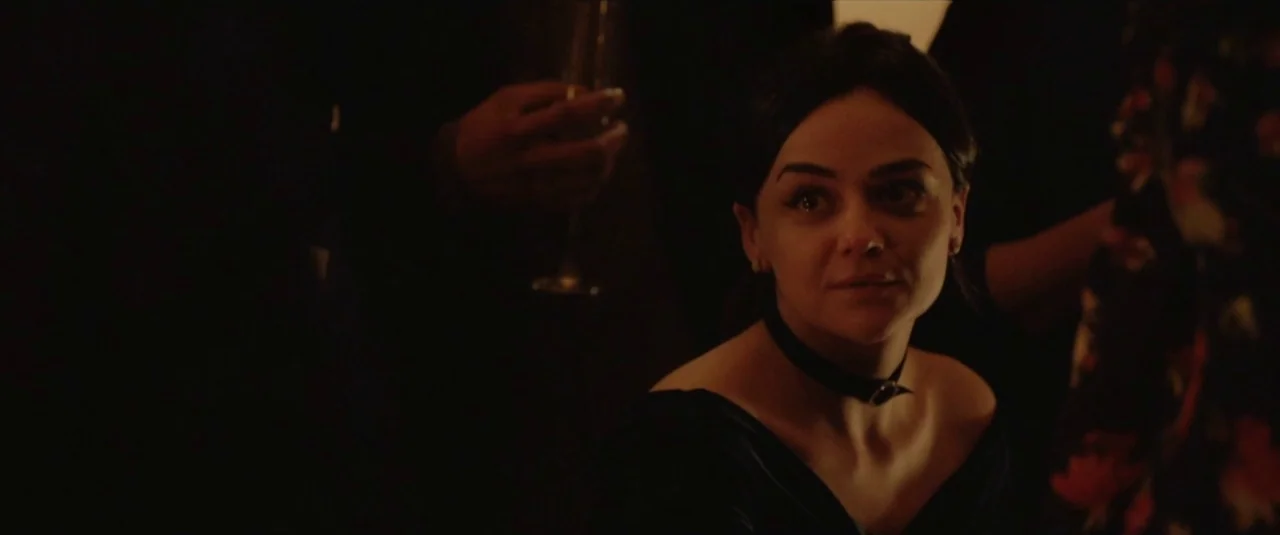 Happy New Year, Colin Burstead (2018) movie still: medium — A dimly lit indoor social event with dark silhouettes and warm ambient light. A woman…