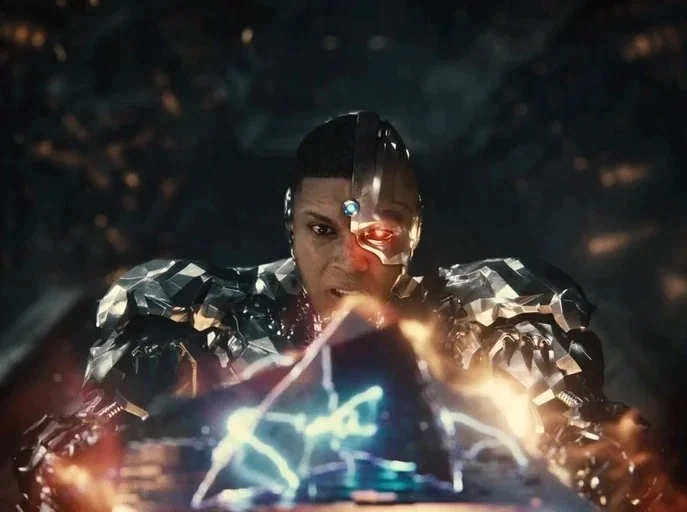 Zack Snyder's Justice League (2021) movie still: medium — A dark, amorphous space surrounds a character encased in complex silver and black armor.…