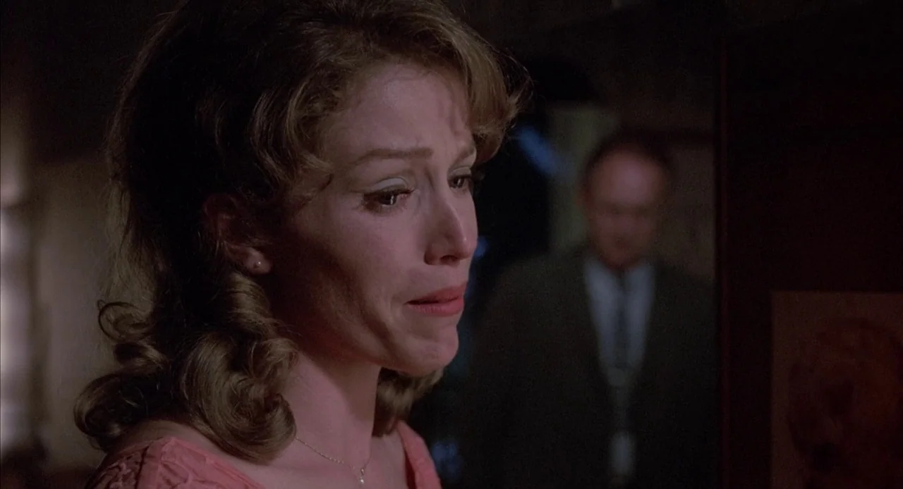 Mississippi Burning (1988) movie still: closeup — A dimly lit room with muted colors creates a focused atmosphere for the two subjects. The woman…