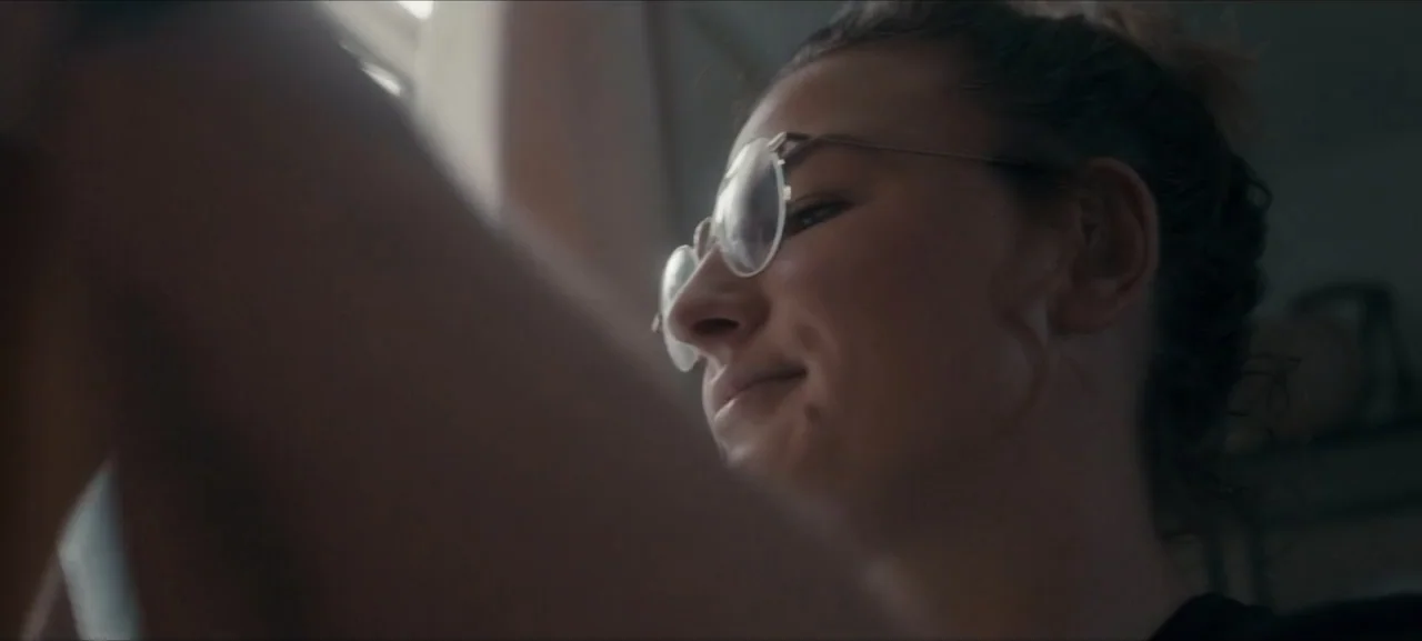 No Woman No Try (2022) movie still: closeup — An interior space with a window allowing daylight to illuminate the subject's side profile. A woman…