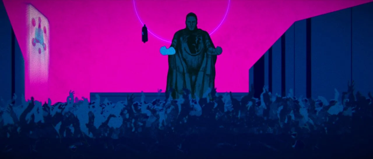 Archenemy (2020) movie still: wide — A dark figure in a cloak stands on a platform against a magenta sky. A large crowd of people with raised arms…
