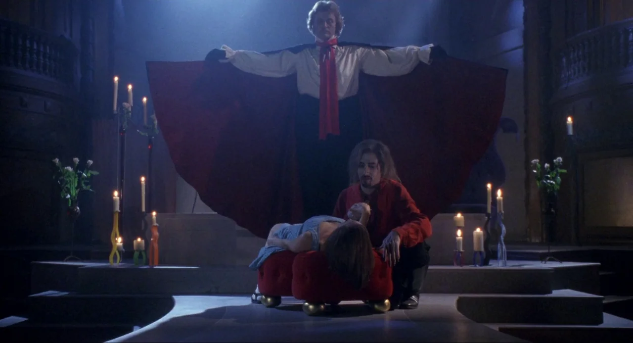 Buffy the Vampire Slayer (1992) movie still: fullbody — A stone crypt interior with multiple burning candles on pedestals and stone steps. A man in…