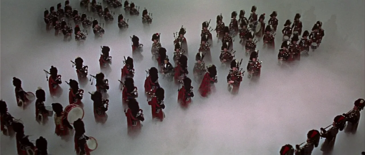 Casino Royale (1967) (1967) movie still: wide — A large regiment of Scottish soldiers marches through a field covered in thick fog. The men wear…