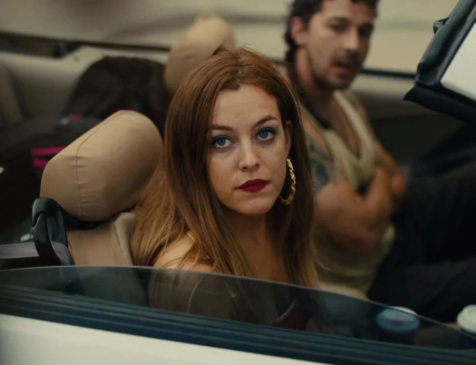 American Honey (2016) movie still: medium — A view from inside a moving convertible vehicle showing the driver and passenger. The woman looks…