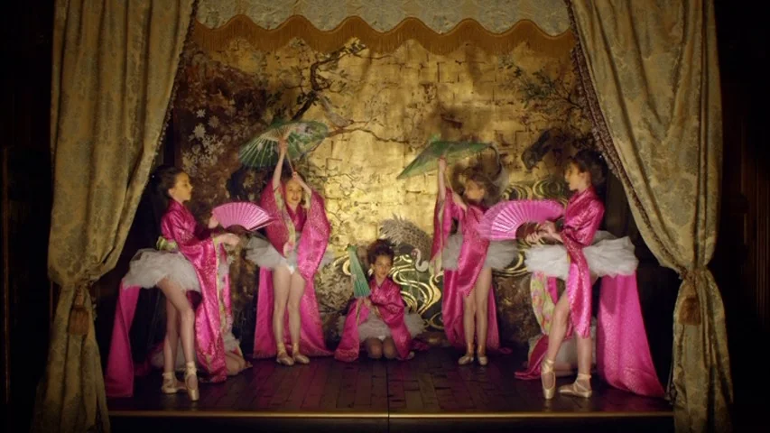 The Sleeping Beauty (2010) movie still: fullbody — A small wooden stage framed by heavy gold curtains features a gold-leafed decorative backdrop.…