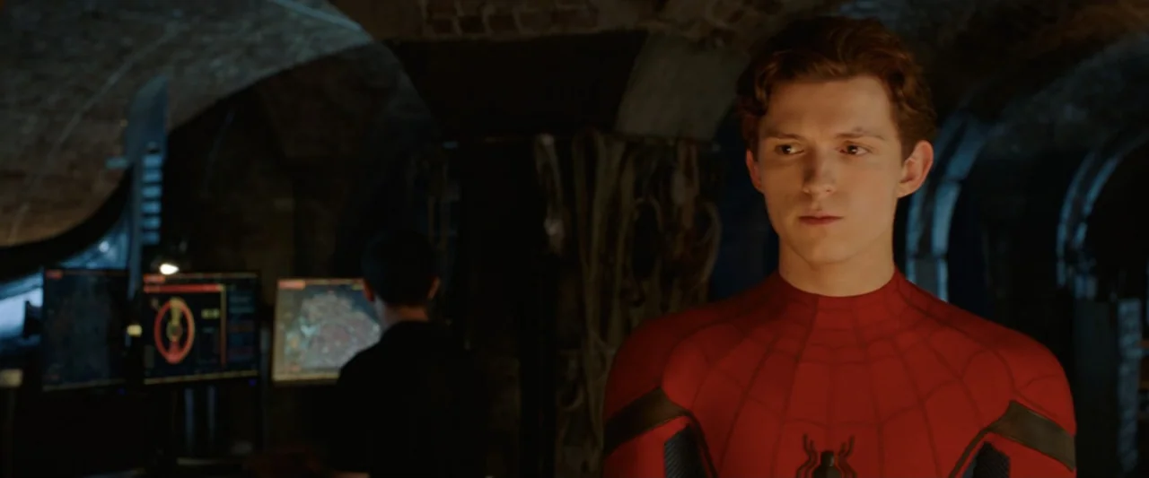 Spider-Man: Far From Home (2019) movie still: medium — A dark, vaulted stone-walled space features multiple glowing computer monitors and cables. A…