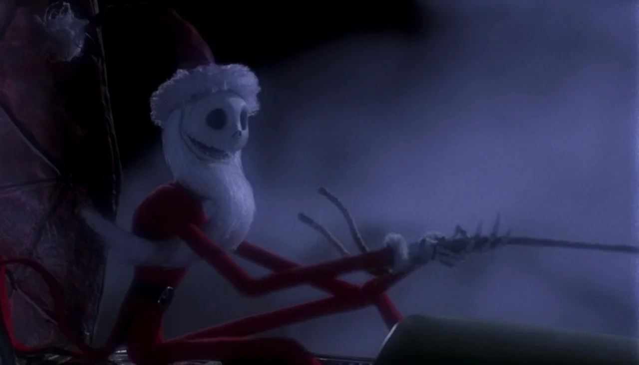 The Nightmare Before Christmas (1993) movie still: medium — A tall skeletal figure sits in a dark sleigh against a night sky. The character wears a…