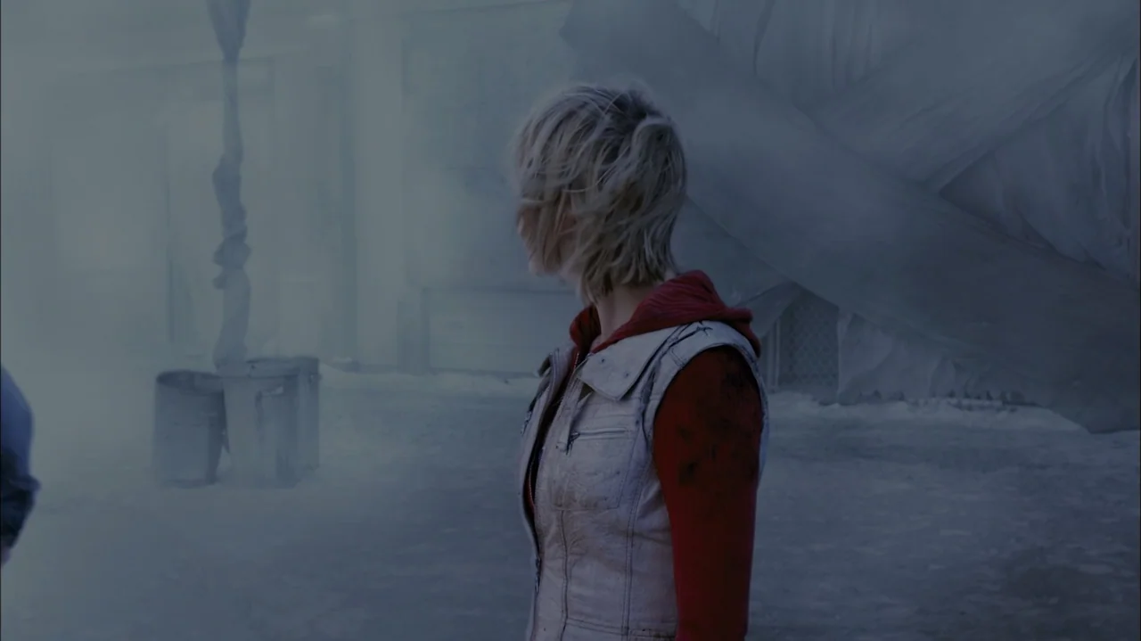Silent Hill: Revelation 3D (2012) movie still: medium — A desolate, snowy area filled with thick fog and indistinct industrial structures. A woman…