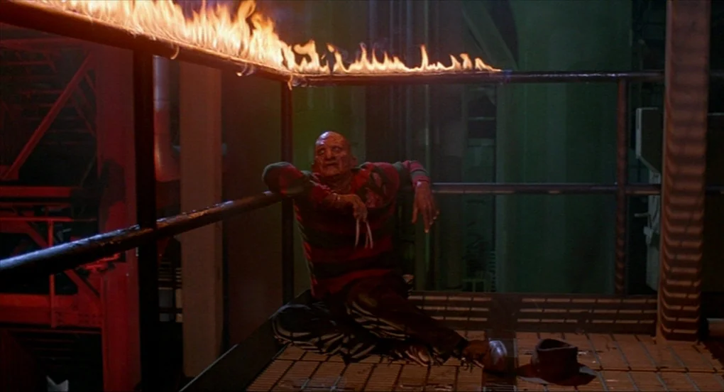 A Nightmare On Elm Street 2: Freddy’s Revenge (1985) movie still: fullbody — An industrial catwalk features a metal grate floor and steel railings…