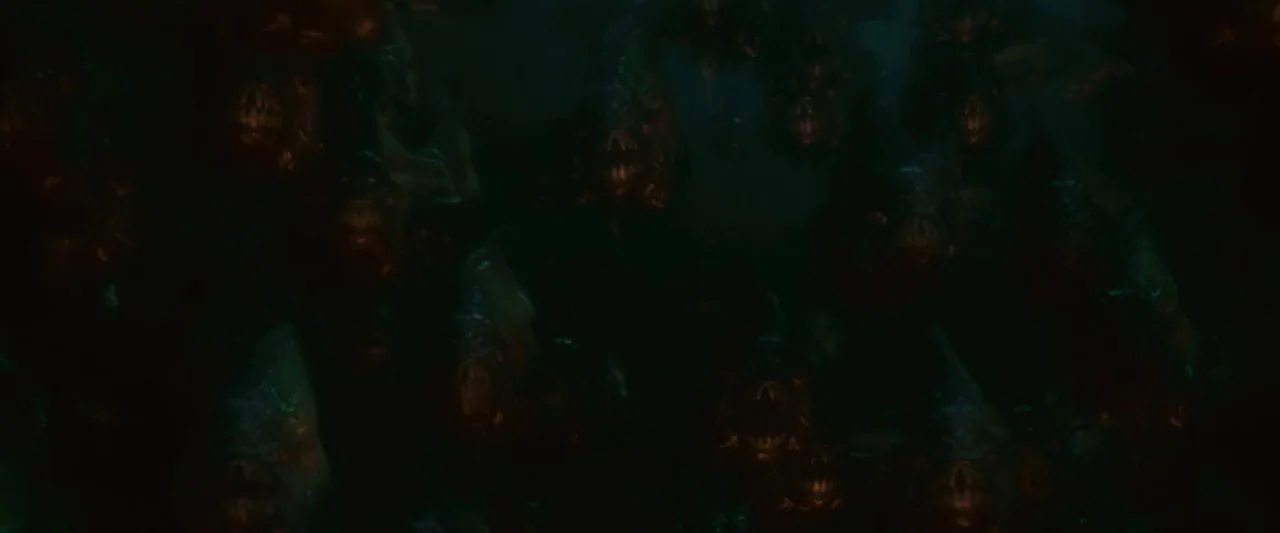Piranha 3D (2010) movie still: wide — A dense school of piranha-like creatures swarms through dark, murky water. The fish display sharp teeth and…