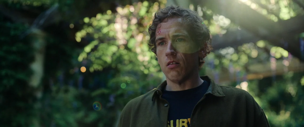 Bodies Bodies Bodies (2022) movie still: medium — An outdoor structure with wooden beams and dense overhanging greenery provides shaded overhead…