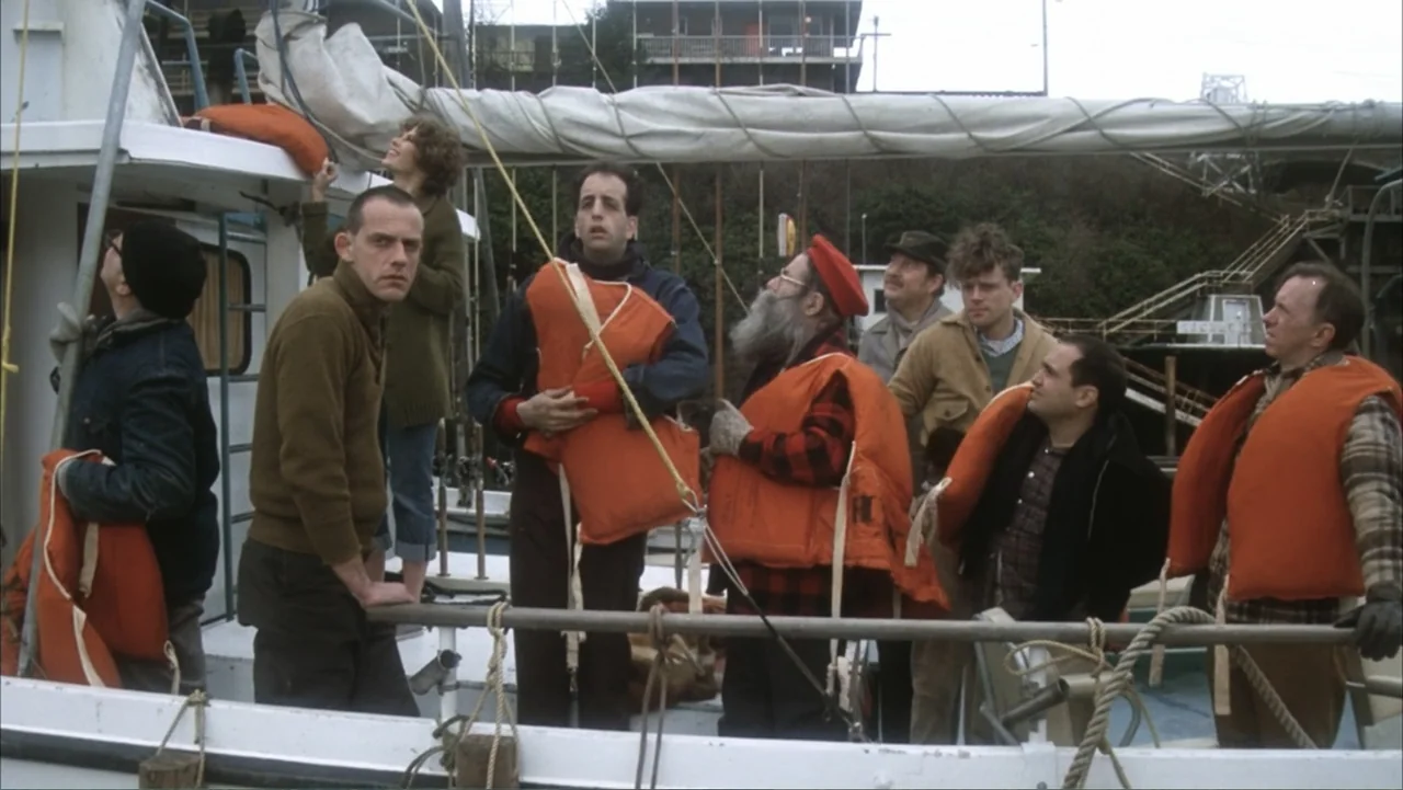 One Flew Over the Cuckoo's Nest (1975) movie still: medium — A boat deck crowded with people wearing bright orange life jackets on an overcast day.…
