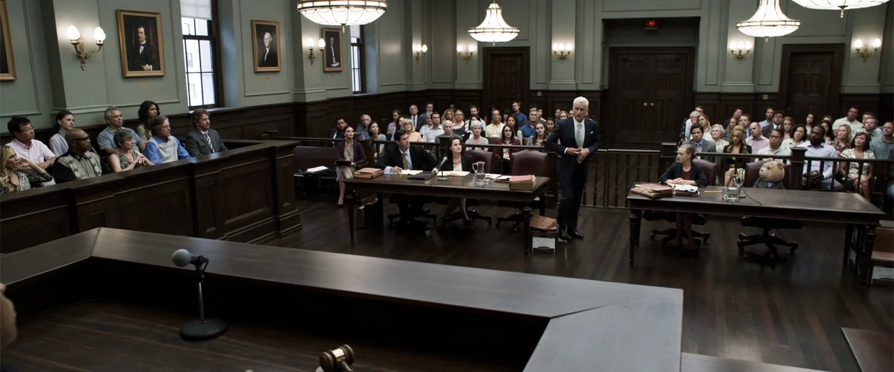 Ted 2 (2015) movie still: wide — A spacious wood-paneled courtroom filled with a jury, spectators, and legal counsel at tables. A man in a dark suit…