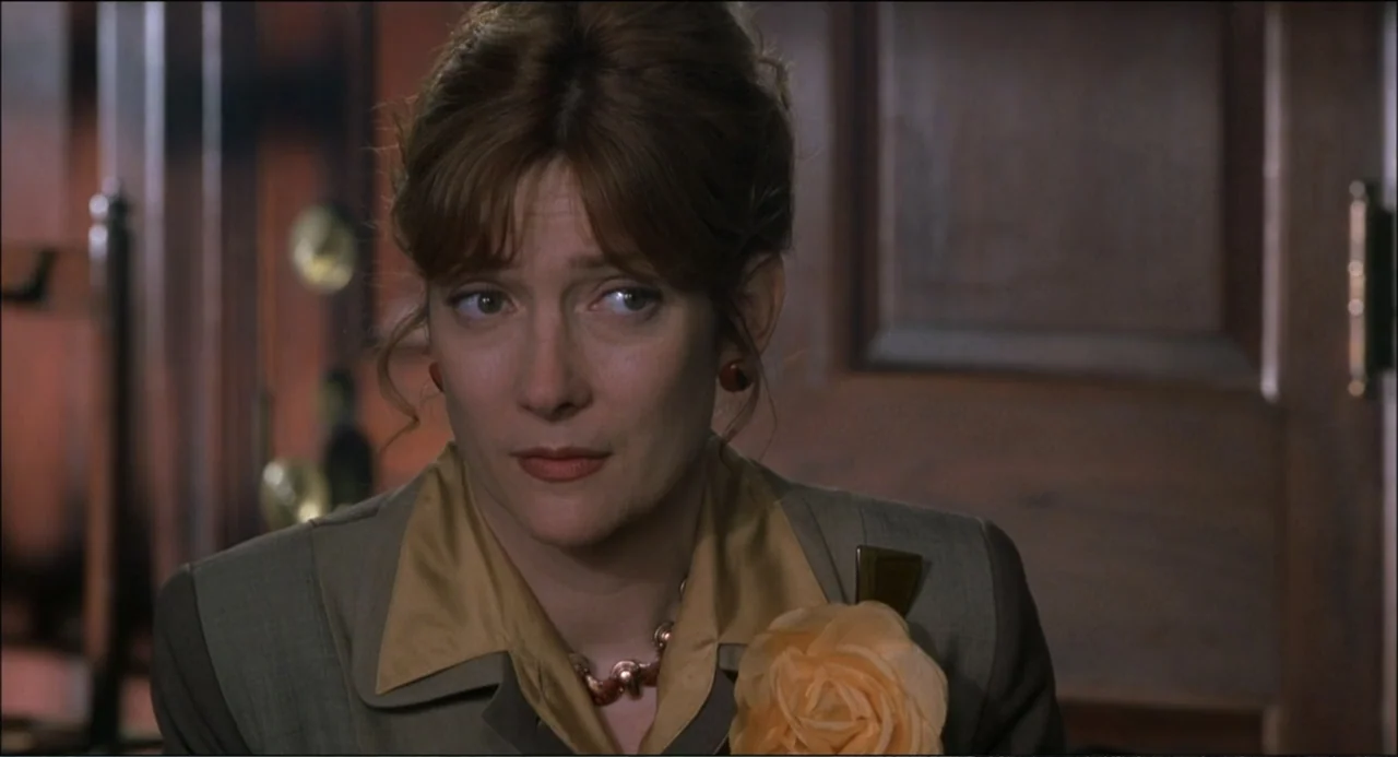 What's the Worst That Could Happen? (2001) movie still: medium — A dimly lit indoor space features wooden paneled walls and structured furniture…