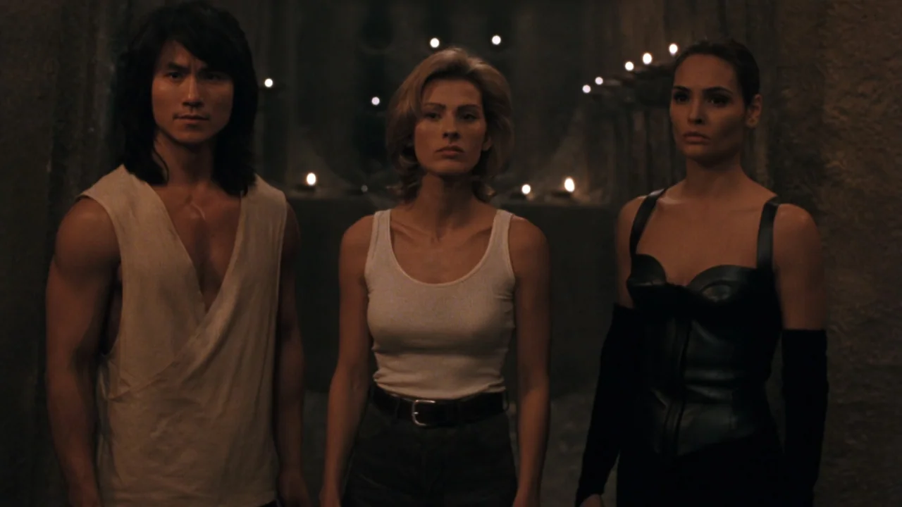 Mortal Kombat: Annihilation (1997) movie still: medium — A stone chamber features walls lined with numerous small lit candles. Three people stand…