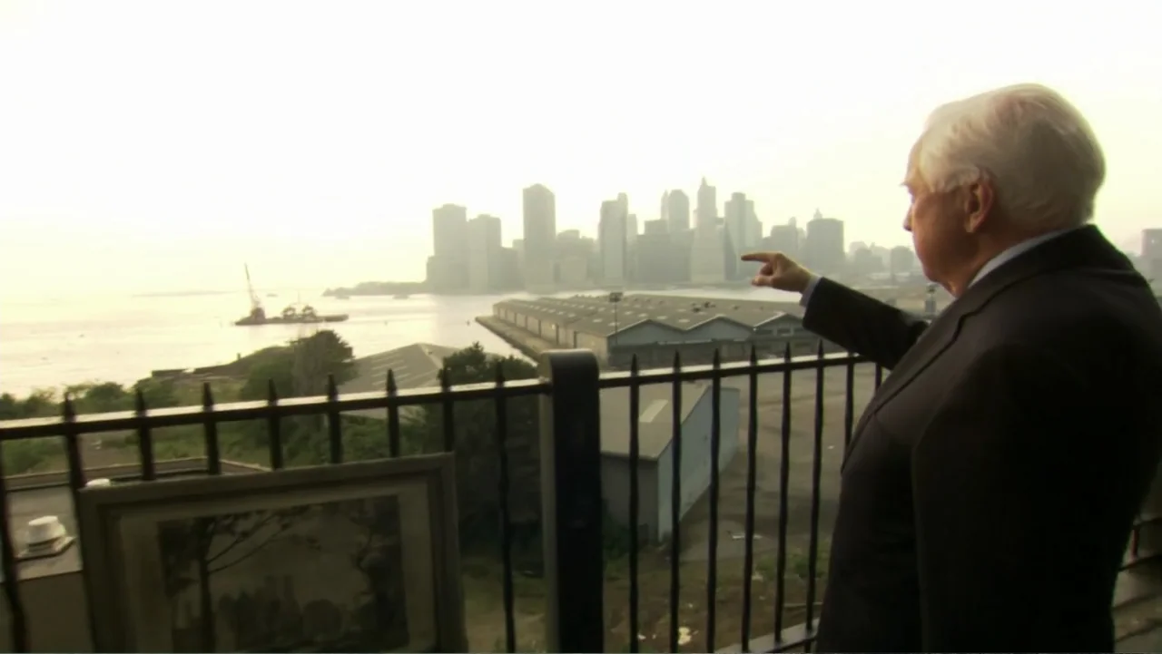 David McCullough: Painting with Words (2008) movie still: medium — A man stands on a terrace looking out over a large body of water. He points his…