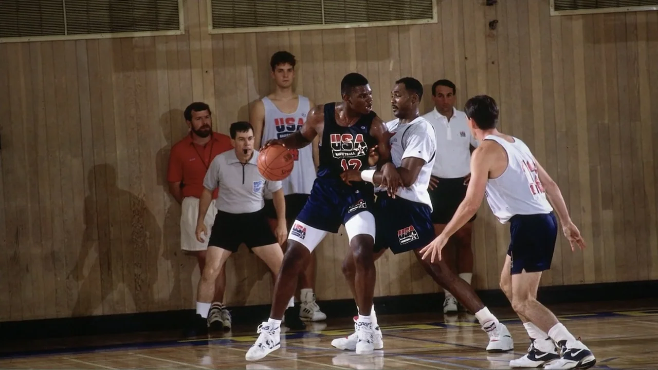 We Beat the Dream Team (2025) movie still: fullbody — An indoor basketball court with wood-paneled walls serves as the training environment. Two…