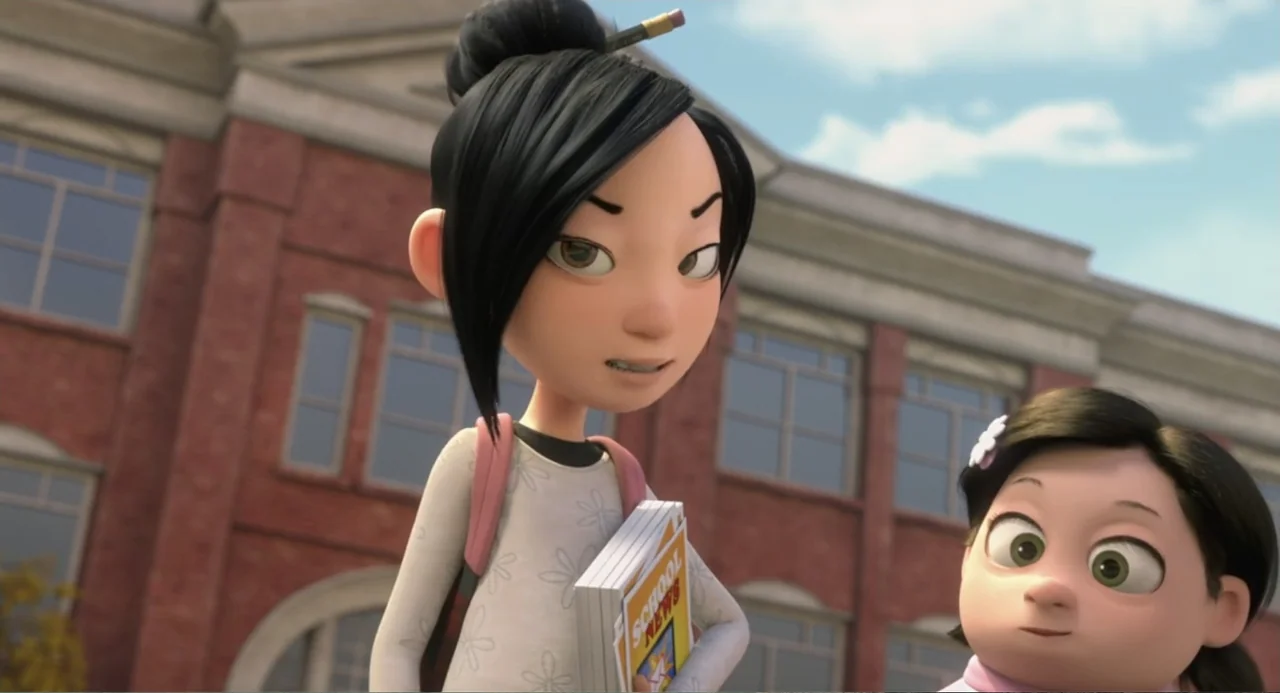 Luis and the Aliens (2018) movie still: medium — A red brick school building serves as the background for two girls. The older girl holds a notebook…