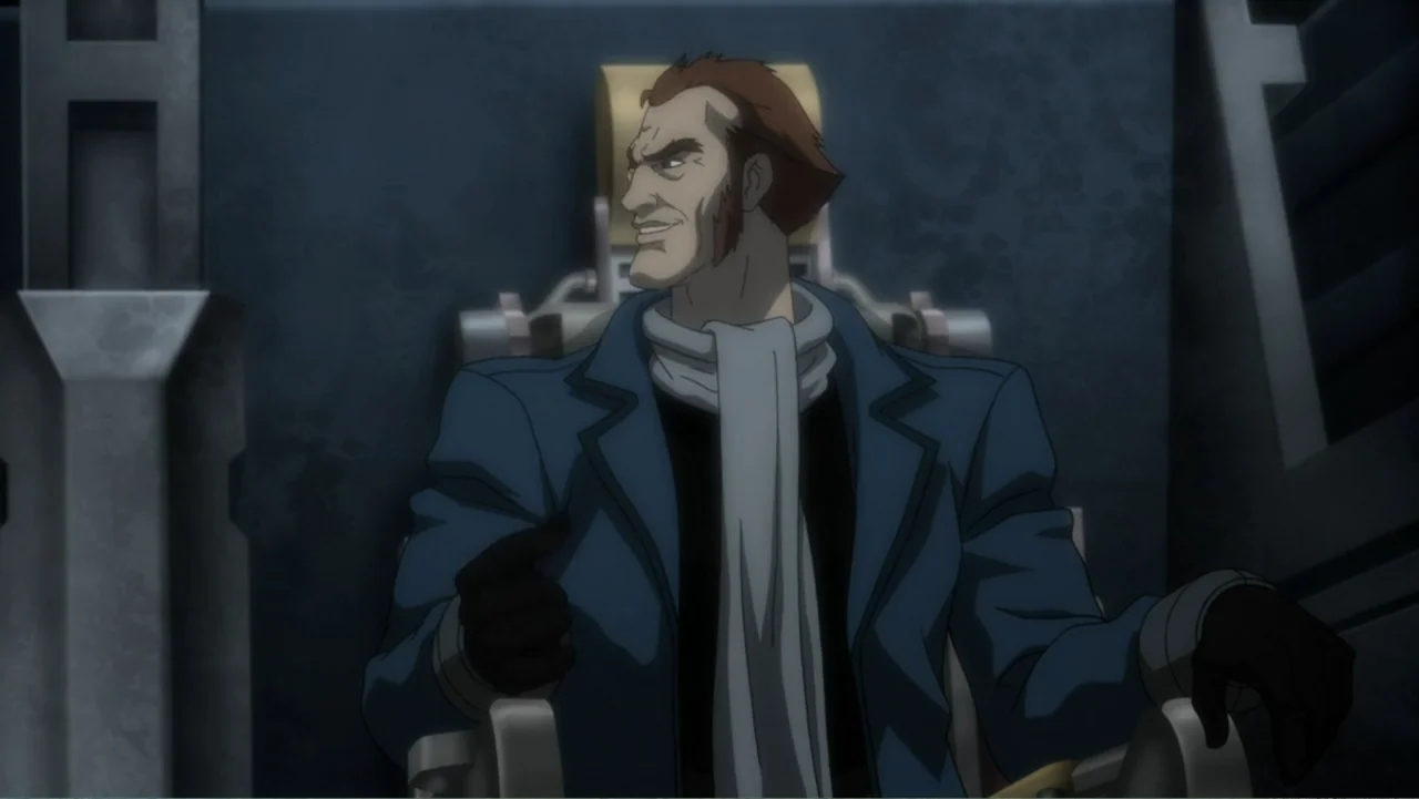 Batman: Assault on Arkham (2014) movie still: medium — A dark, industrial interior features a metallic chair against a slate blue wall. A man with…