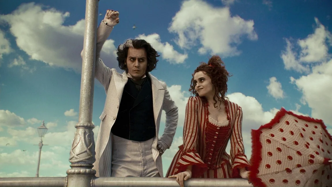 Sweeney Todd: The Demon Barber of Fleet Street (2007) movie still: medium — A wooden pier structure sits against a bright blue sky filled with white…