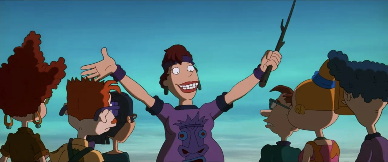 Rugrats Go Wild (2003) movie still: medium — A group of animated figures stands outdoors against a clear blue sky. A central adult woman gestures…