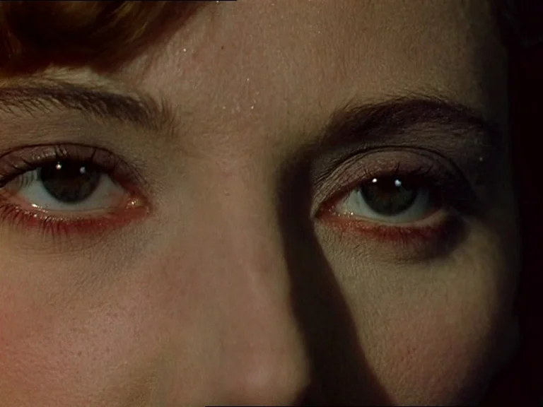 Black Narcissus (1947) movie still: closeup — A extreme close-up focuses entirely on the eyes and bridge of a woman's nose. A sharp shadow bisects…
