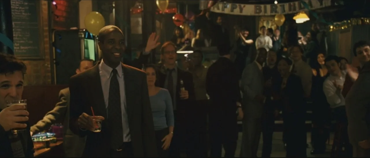 Definitely, Maybe (2008) movie still: medium — A crowded bar interior decorated with yellow birthday balloons and a banner hanging overhead. A man…