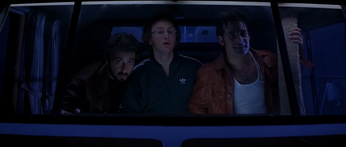 Carlito’s Way (1993) movie still: medium — Three men are positioned inside the front cabin of a moving vehicle at night. They peer through the…