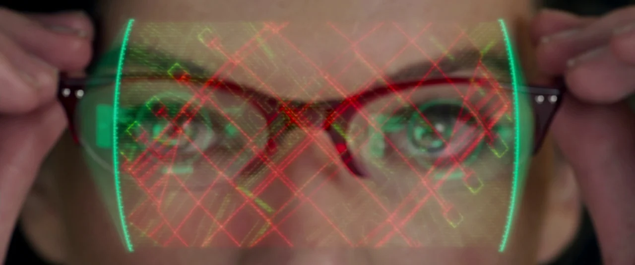 Resident Evil: Retribution (2012) movie still: closeup — A close up view shows a person wearing glasses with a digital interface projected over…