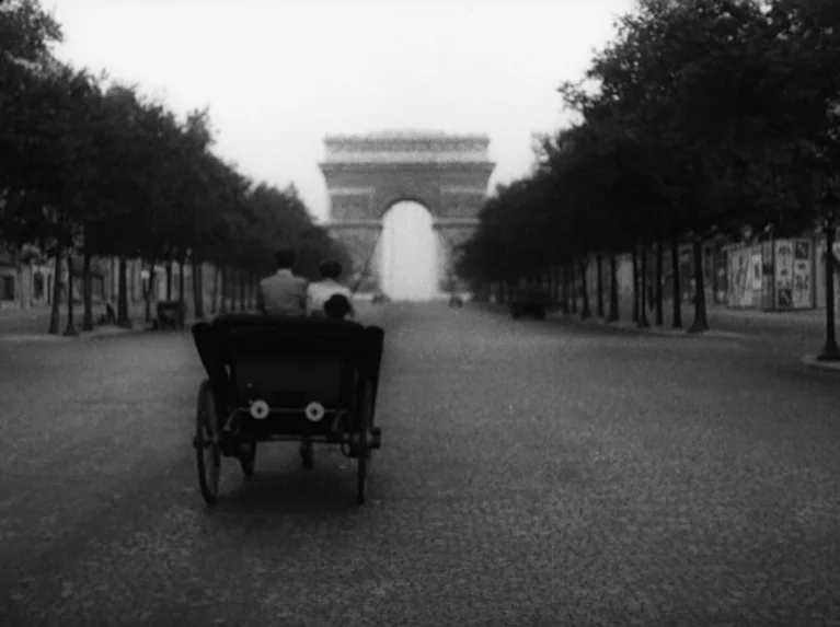 Waiting Women (1952) movie still: wide — A wide view of a Parisian boulevard lined with trees leading toward a monument. A horse-drawn carriage…