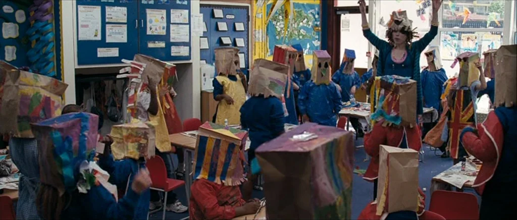 Happy-Go-Lucky (2008) movie still: wide — A busy elementary classroom features walls covered in educational posters and student artwork displays. A…