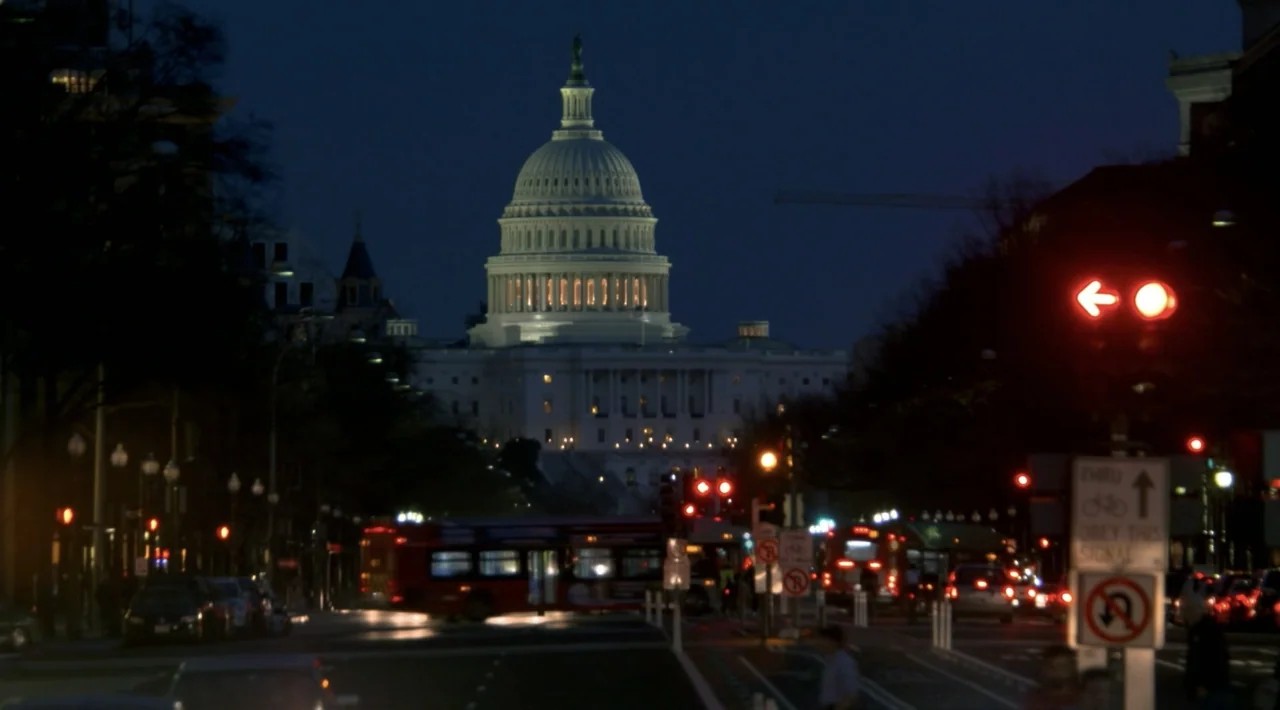 The Divided Soul of America (2019) movie still: establishing — A view of the United States Capitol dome looms over a darkened urban intersection.…
