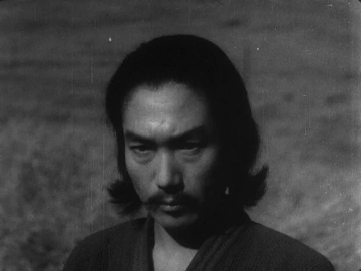 Sanshiro Sugata (1943) movie still: closeup — An outdoor field serves as the backdrop for this character portrait. A man with shoulder-length dark…