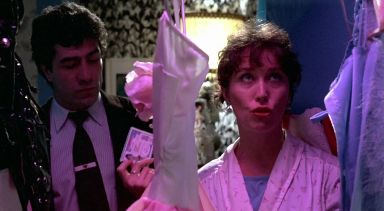 What Have I Done To Deserve This? (1984) movie still: medium — A cramped, cluttered space filled with hanging garments and patterned wallpaper…