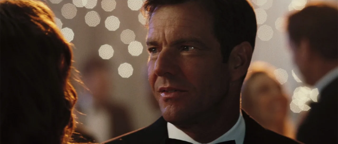 Yours, Mine & Ours (2005) movie still: closeup — A dimly lit ballroom interior features a crowd with bokeh lights in the distance. A middle-aged man…