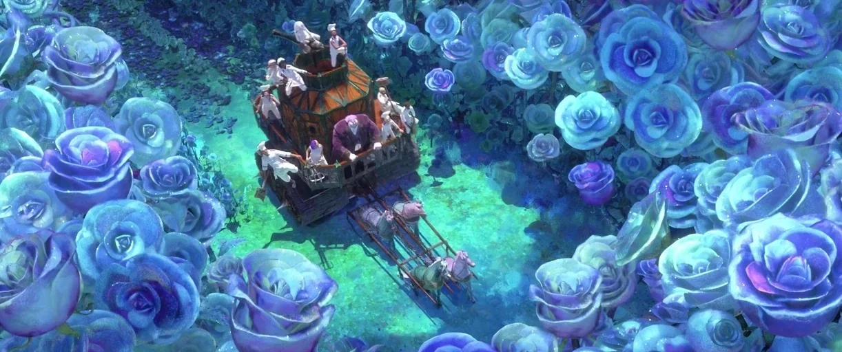 Puss in Boots: The Last Wish (2022) movie still: wide — A field of oversized blue roses surrounds a path occupied by a wooden cart. Several small…