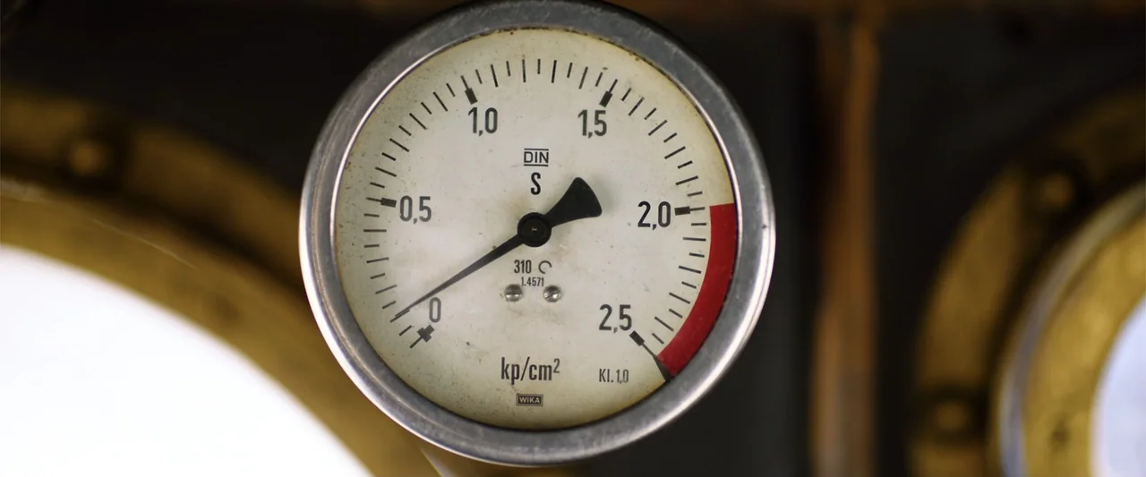 Jim Button and Luke the Engine Driver (2018) movie still: closeup — A close-up view of a circular analog pressure gauge with a metallic frame. The…