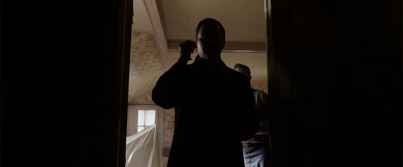 Annabelle: Creation (2017) movie still: medium — A dark, silhouetted man stands in a doorway looking into a bright lit room. The bedroom contains…