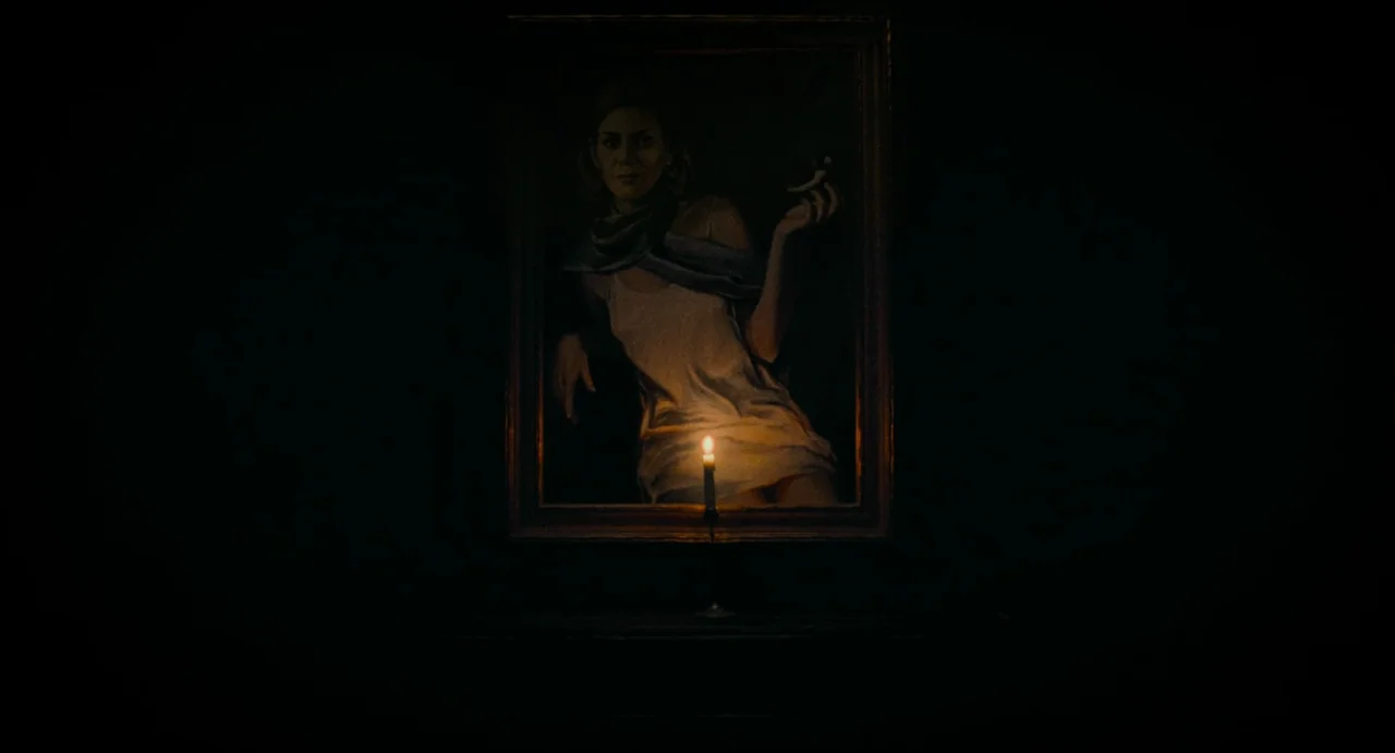 La Abuela (2021) movie still: medium — A dark space features a central painting of a woman mounted on a wall. A single lit candle stands on a narrow…