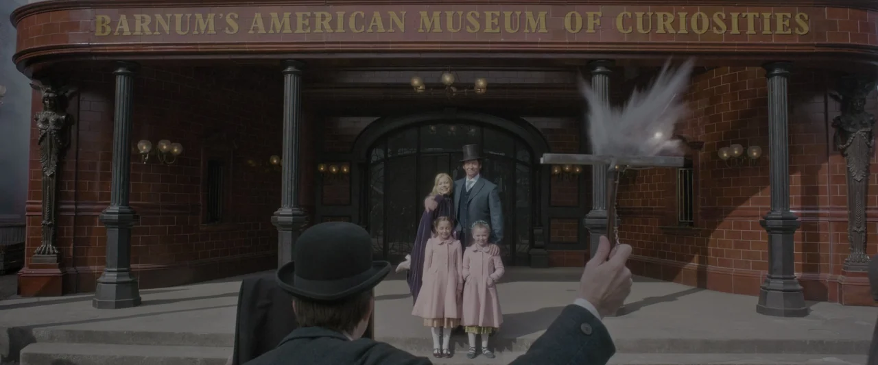 The Greatest Showman (2017) movie still: fullbody — A red-brick building with dark pillars features a golden sign reading Barnum's American Museum.…