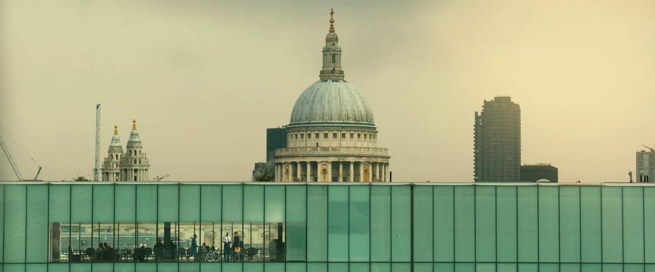 Trance (2013) movie still: wide — A wide view of the London skyline features the dome of St Paul's Cathedral. A modern glass-fronted building in the…