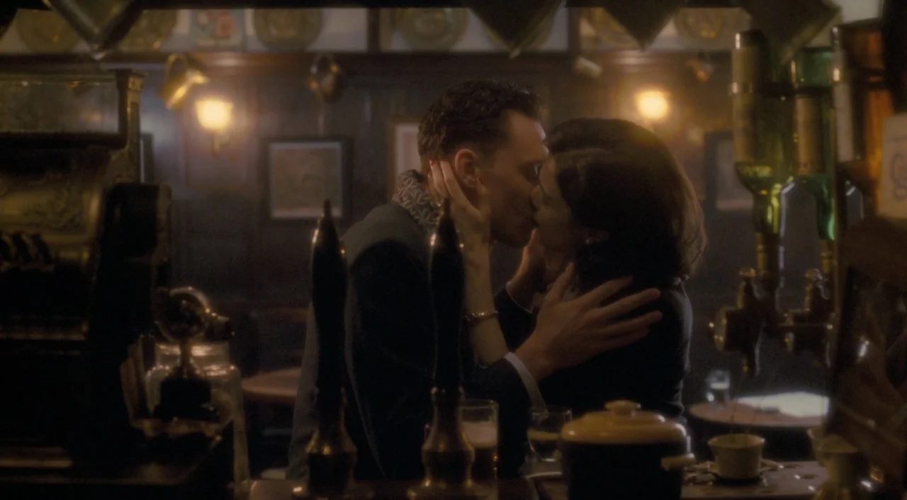 The Deep Blue Sea (2011) movie still: medium — A dimly lit traditional British pub with wood-paneled walls and brass beer taps. A man and woman…
