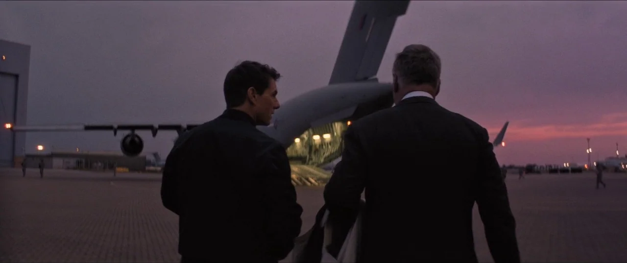 Mission: Impossible – Fallout (2018) movie still: fullbody — A military airfield at sunset with a large transport aircraft parked in the background.…