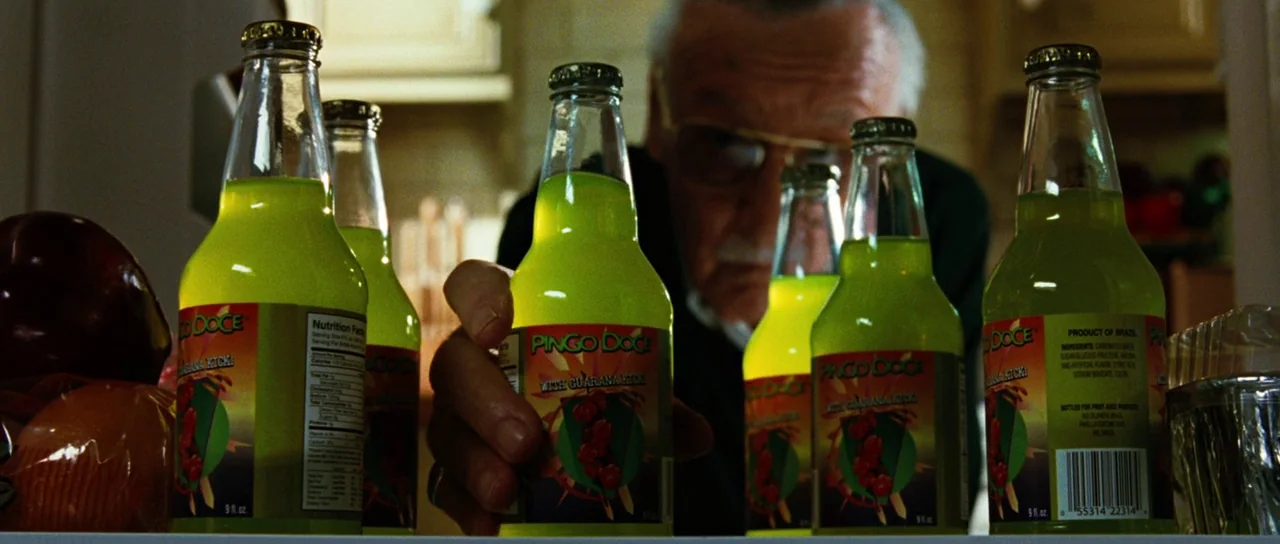 The Incredible Hulk (2008) movie still: closeup — An elderly man peers into the shelves of a well-stocked residential refrigerator unit. He reaches…
