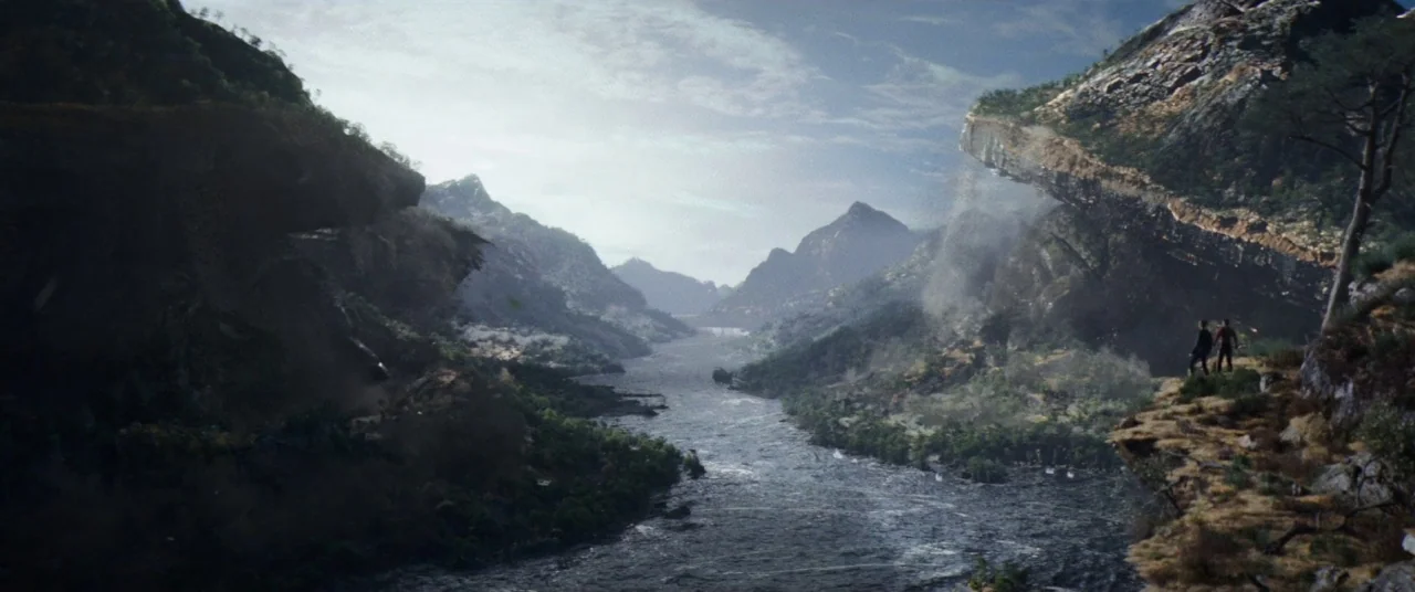 Pokémon Detective Pikachu movie still: wide — A vast mountain valley features a fast-flowing river carved between steep rocky cliffs. Two small…