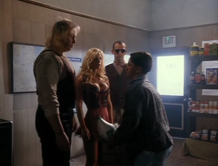 Head of the Family (1996) movie still: Four diverse characters are gathered inside a dated convenience store, suggesting a tense or significant…