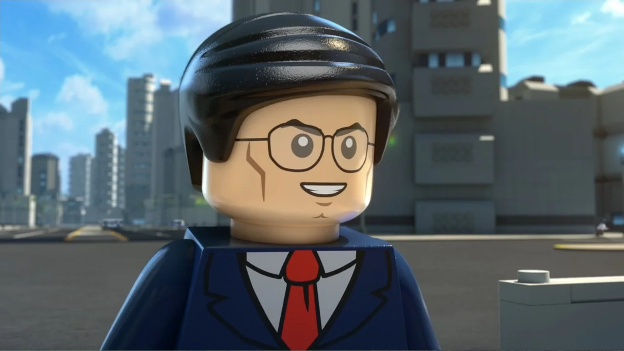 LEGO DC: Shazam! Magic and Monsters (2020) movie still: closeup — A Lego minifigure stands in an urban environment with grey buildings in the…