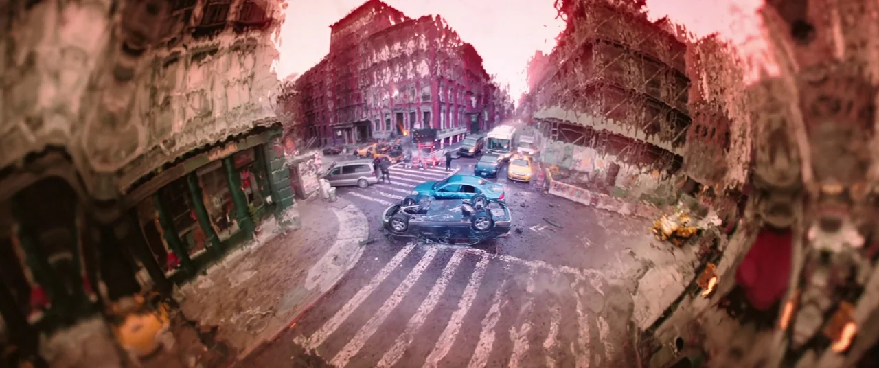 Doctor Strange in the Multiverse of Madness (2022) movie still: wide — A city intersection features a severely overturned silver car amidst heavy…